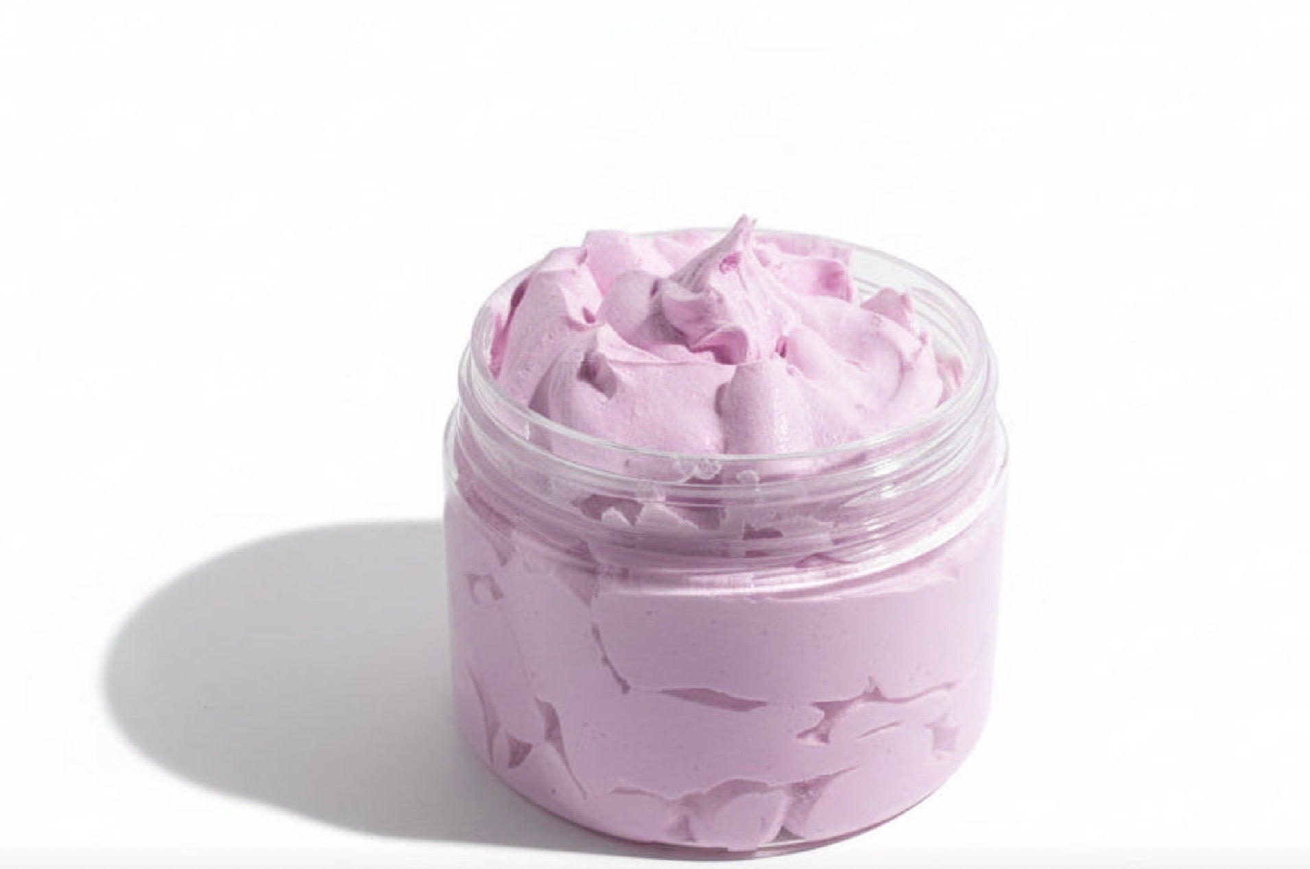 Jar of pink body scrub on a white background