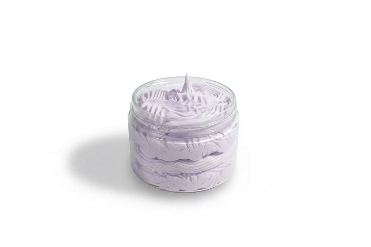 Clear container with purple body scrub on a white background