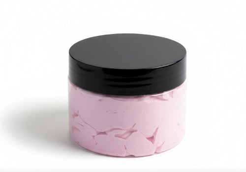 Pink plastic jar of body scrub with black lid on a white background